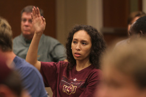 Elascha Hicks, mass communication junior, raises her hand to give her opinion on what Academic Search should look for when selecting presidential candidates in Dillard College of Business Administration Monday. Photo by Lauren Roberts