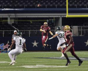 Jake Glover, quarterback, throws the ball at Midwestern State University v. Eastern New Mexico game at AT&T Cowboys Stadium in Arlington, Sept. 20, 2014. Photo by Rachel Johnson