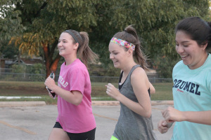 Amy Melholland, marketing junior, Taylor Sikes.sociology senior, and Sandra Alonzo, nursing senior, running together on their first lap of the Superhero 5K around the Sikes Lake trail on Sept. 28. Photo by Kayla White.