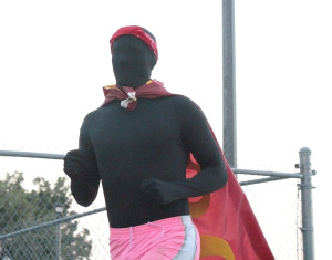 Ian "The Stang Man"  Thompson, special education junior, running in his black morphsuit with the MSU flag tied around his neck at the Superhero 5K around the Sikes Lake trail on Sept. 28. Photo by Kayla White.