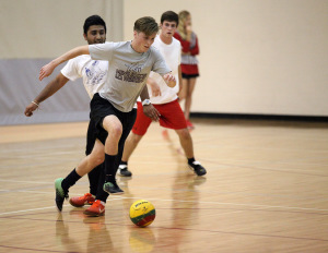 Zane Horton, criminal justice freshman receives a pass then avoids Drew Skinner, biology senior, and Manny Bhogal, marketing senior, at the recreational sports in the Wellness Center where TKE beat FC Mustangs 4-0, Oct. 13. Photo by Francisco Martinez