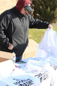 Mario Ramirez, activities coordinator student development and orientation, sets up the t-shirt table during the 1 mile Cookie Dash put on by the University Programming Board at Sikes Lake, Jan, 23. Photo by Francisco Martinez