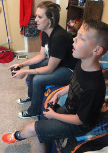 acklyn York, mass communication junior, and her son Braiden York play their favorite video game together in Braiden's room. Photo by Rachel Johnson