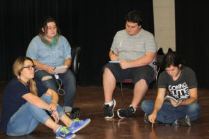 Sarah Dempsey, theater sophomore, Hope Harwick, theater junior, Dean Hart, theater sophomore, and Joey McGrinn, theater sophomore, listen to notes during rehearsal for "Speech and Debate," Sept. 15. Photo by Brendan Wynne