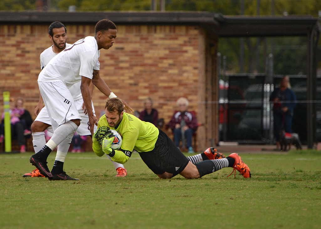 Leon Taylor tries to break a fall by Goalie Noah Fazekas at the Heartland Conference playoff game against St. Edward's. MSU lost 0-2. Photo by Zack Santagate