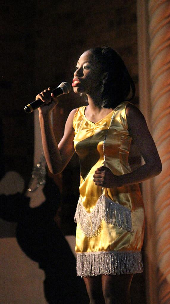 Indira Placide, biology junior, speaks passionately about the problems with low self-esteem in the introduction portion during the Caribfest Pageant Wednesday night in Akin Auditorium. Pageant started 45 minutes late, but the house was still packed with more than 300 people for the show. Five contestants competed in the Miss Caribfest Pageant, with Indira Placide winning the crown. Photo by Rachel Johnson