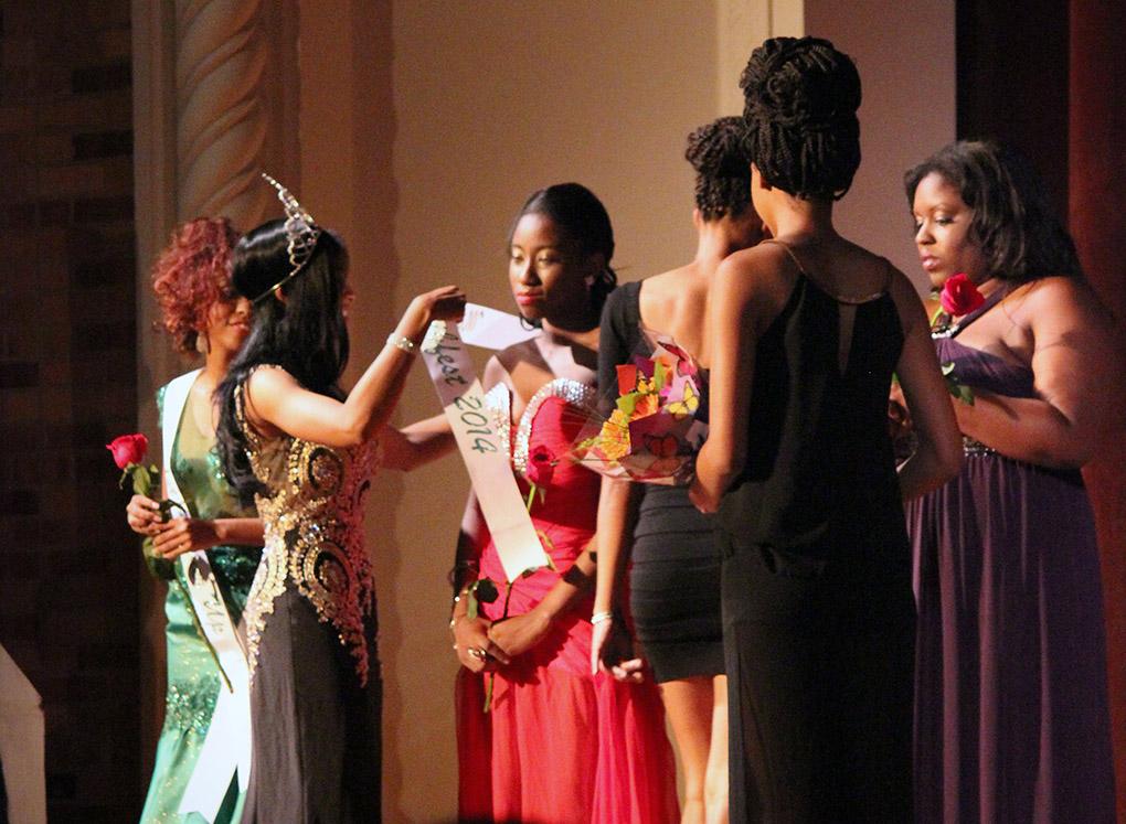 Indira Placide, biology junior, is presented with her sash and crown as she is annouced as the Miss Caribfest 2014 during the Caribfest Pageant Wednesday night in Akin Auditorium. Pageant started 45 minutes late, but the house was still packed with more than 300 people for the show. Five contestants competed in the Miss Caribfest Pageant, with Indira Placide winning the crown. Photo by Rachel Johnson