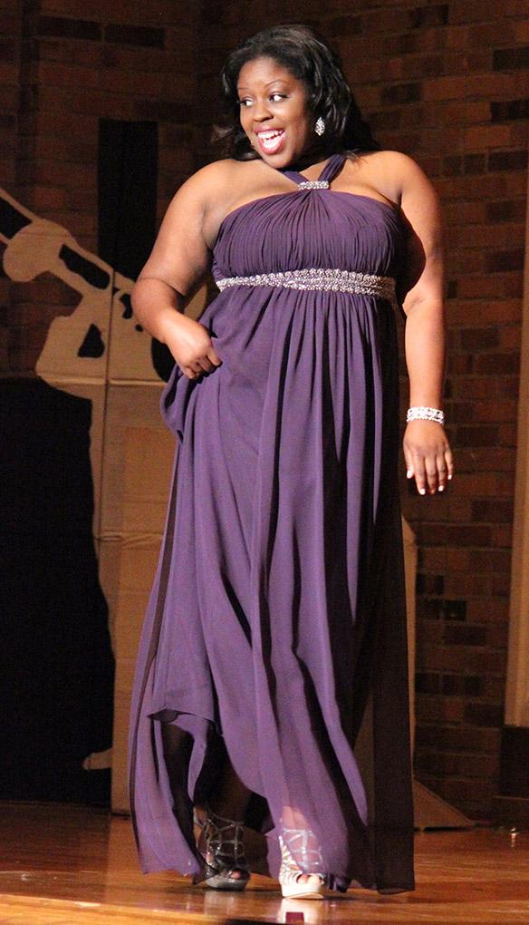 Valencia Morris, nurse junior, shows off her evening dress during the Caribfest Pageant Wednesday night in Akin Auditorium. Pageant started 45 minutes late, but the house was still packed with more than 300 people for the show. Five contestants competed in the Miss Caribfest Pageant, with Indira Placide winning the crown. Photo by Rachel Johnson