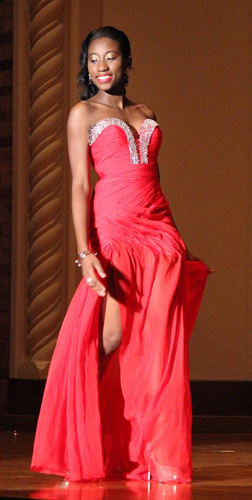 Indira Placide, biology junior, shows off her evening gown during the Caribfest Pageant Wednesday night in Akin Auditorium. Pageant started 45 minutes late, but the house was still packed with more than 300 people for the show. Five contestants competed in the Miss Caribfest Pageant, with Indira Placide winning the crown. Photo by Rachel Johnson