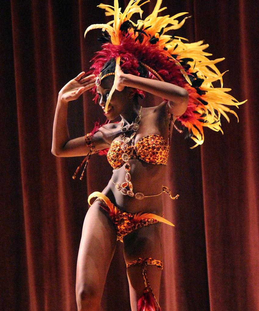 Indira Placide, biology junior, dances in her costume in the Costume and Personality portion during the Caribfest Pageant Wednesday night in Akin Auditorium. Pageant started 45 minutes late, but the house was still packed with more than 300 people for the show. Five contestants competed in the Miss Caribfest Pageant, with Indira Placide winning the crown. Photo by Rachel Johnson