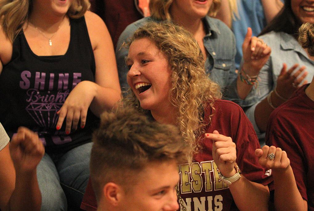 Madeline Schorlemmer, junior in psychology, laughes after successfully removing her finger from the person next to at Convocation Tuesday evening. Photo by Lauren Roberts