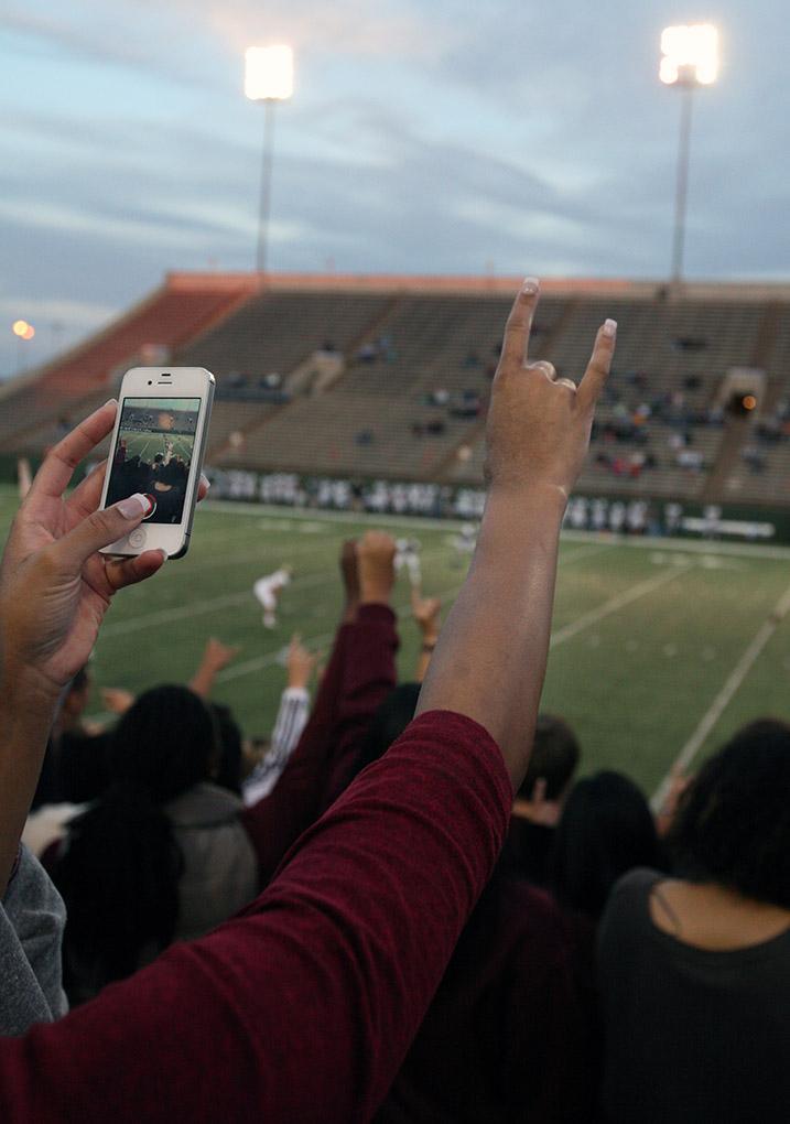 Students live streaming the highlights of the game while showing some school spirit at the game Saturday night. Midwestern defeated Missouri Science and Technology 40-23 at Memorial Stadium. Photo by Rachel Johnson
