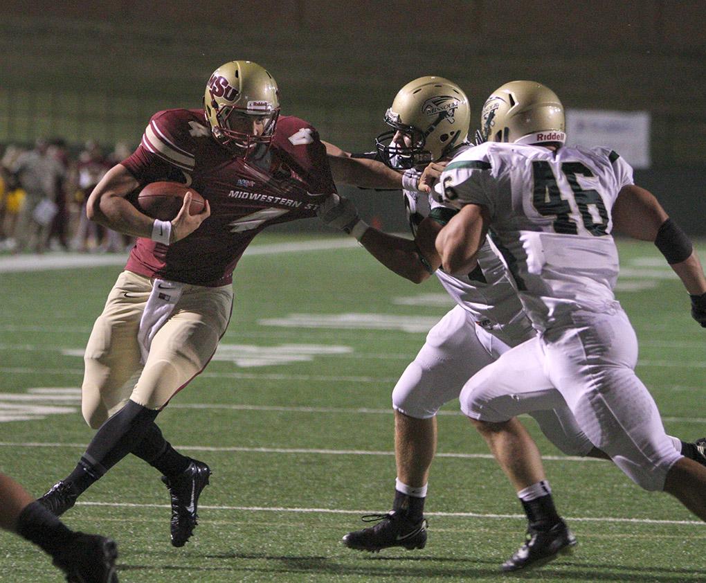 Jake Glover, accounting senior, is pulled down near the endzone at the season opener against Missouri University of Science and Technology. Midwestern State University defeated Missouri S&T 40-23 Saturday night at Memorial Stadium. Photo by Lauren Roberts