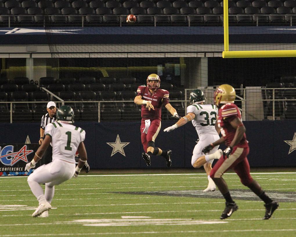 Jake Glober, quarterback, throws the ball at Midwestern State University v. Eastern New Mexico game at AT&T Cowboys Stadium in Arlington, Sept. 20, 2014. Photo by Rachel Johnson