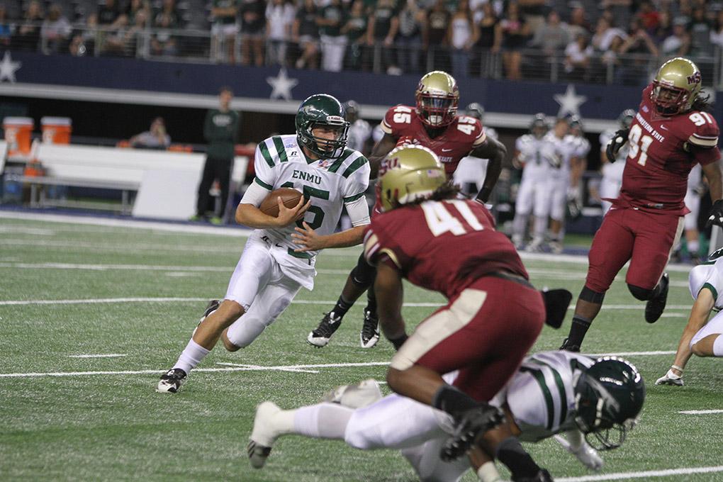 Eastern New Mexico quarterback Jeremy Buurma runs with the ball at Midwestern State University v. Eastern New Mexico game at AT&T Cowboys Stadium in Arlington, Sept. 20, 2014. Photo by Lauren Roberts