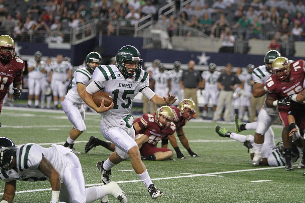 Eastern New Mexico quarterback Jeremy Buurma runs with the ball at Midwestern State University v. Eastern New Mexico game at AT&T Cowboys Stadium in Arlington, Sept. 20, 2014. Photo by Lauren Roberts
