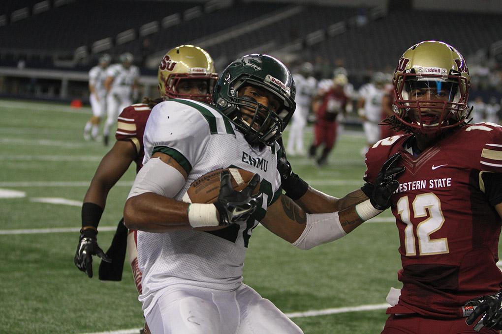 Eastern New Mexico running back Jordan Wells is run out of bounds by Midestern State University's Herb Whitehurst, kinesiology junior, at Midwestern State University v. Eastern New Mexico game at AT&T Cowboys Stadium in Arlington, Sept. 20, 2014. Photo by Lauren Roberts