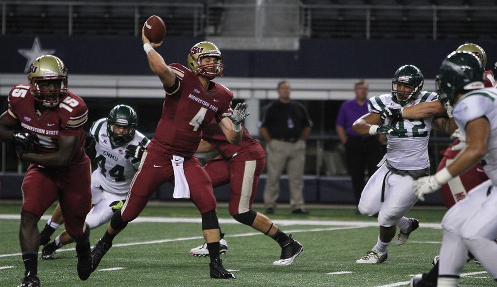 Quarterback Jake Glover, accounting senior, throws the ball at Midwestern State University v. Eastern New Mexico game at AT&T Cowboys Stadium in Arlington, Sept. 20, 2014. Photo by Lauren Roberts