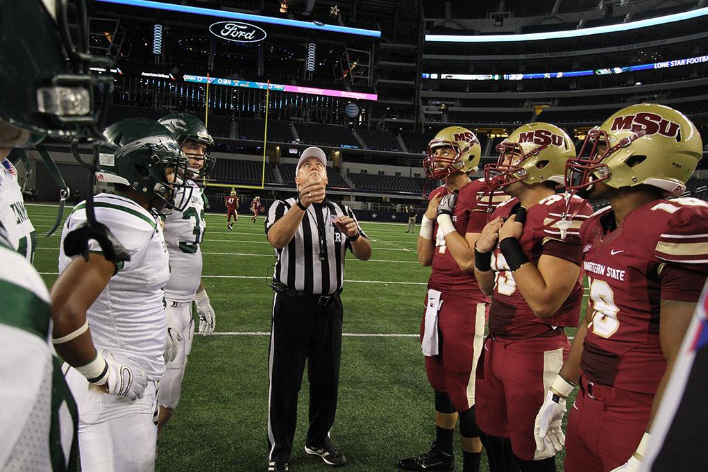Jake Glover, accounting senior,  Daniel Laudermilk, history junior, Ricardo Riascos, criminal justice senior, and Shadow Stokes, exercise physiology senior, join Eastern New Mexico captains for the coin toss at Midwestern State University v. Eastern New Mexico game at AT&T Cowboys Stadium in Arlington, Sept. 20, 2014. Photo by Lauren Roberts