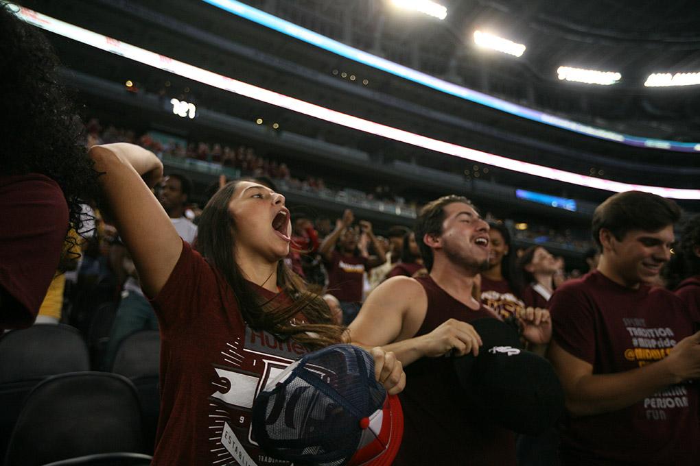 Malaeni Ramos, biology freshman, cheers the Mustangs on with friends at the Midwestern State University v. Eastern New Mexico game at AT&T Cowboys Stadium in Arlington, Sept. 20, 2014. Photo by Rachel Johnson