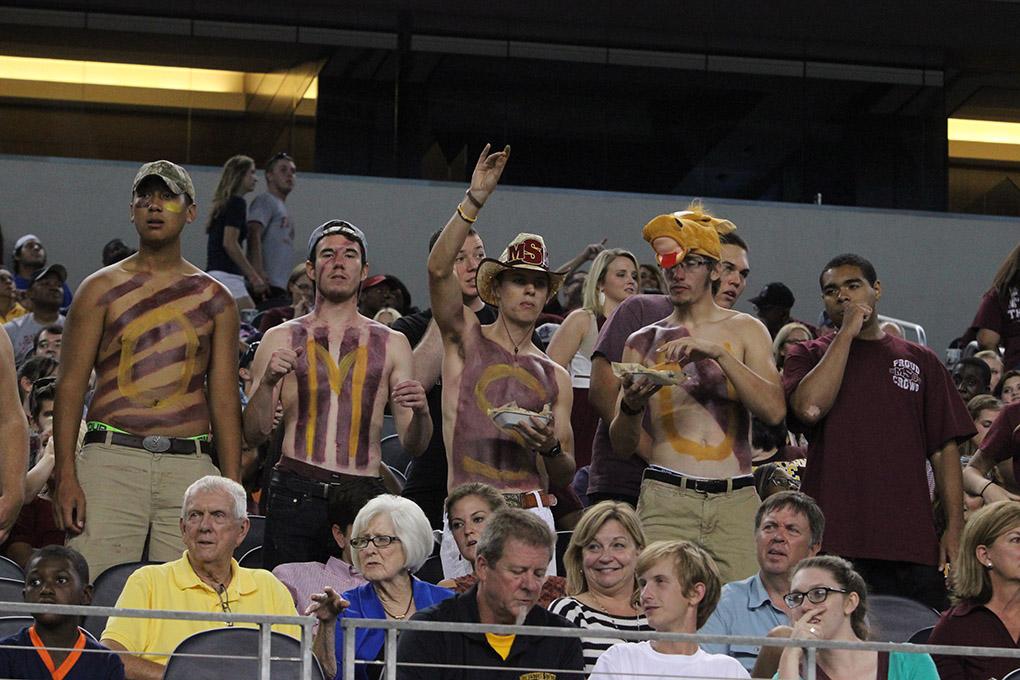 Kevin Nop, mechanical engineering freshman, Zach Davis, history and education freshman, Coleman Reidling, history sophomore, and Brandon Allen, mechanical engineering sophomore, cheers as members of the stang gang at Midwestern State University v. Eastern New Mexico game at AT&T Cowboys Stadium in Arlington, Sept. 20, 2014. Photo by Rachel Johnson