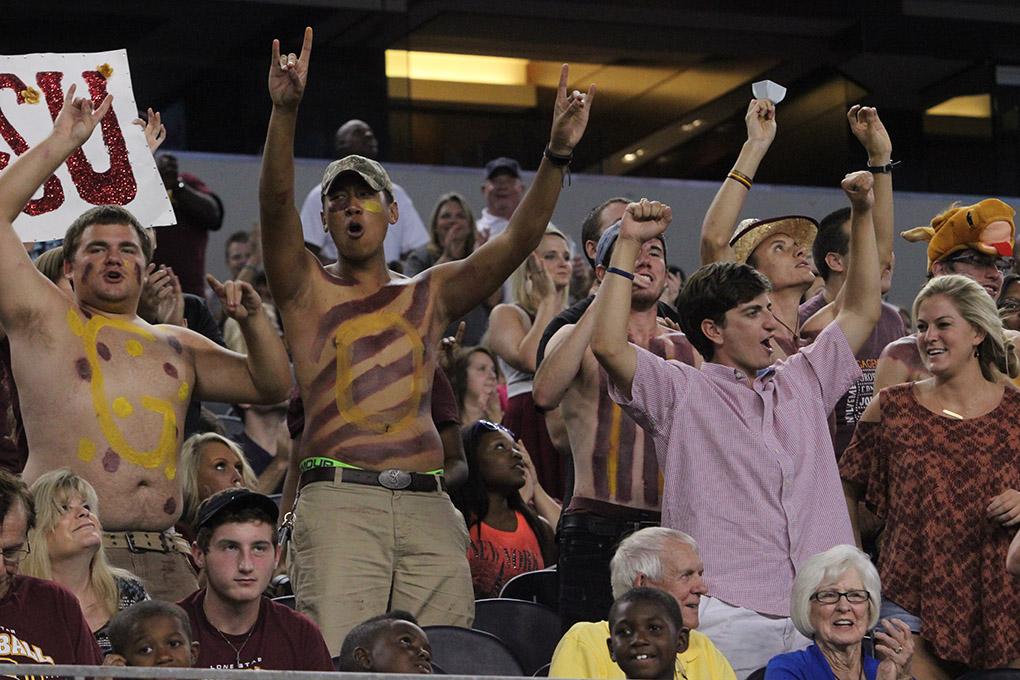 Micah Whitworth, criminal justice freshman, and Kevin Nop, mechanical engineering freshman, cheer with the stang gang and surroundung students at Midwestern State University v. Eastern New Mexico game at AT&T Cowboys Stadium in Arlington, Sept. 20, 2014. Photo by Rachel Johnson