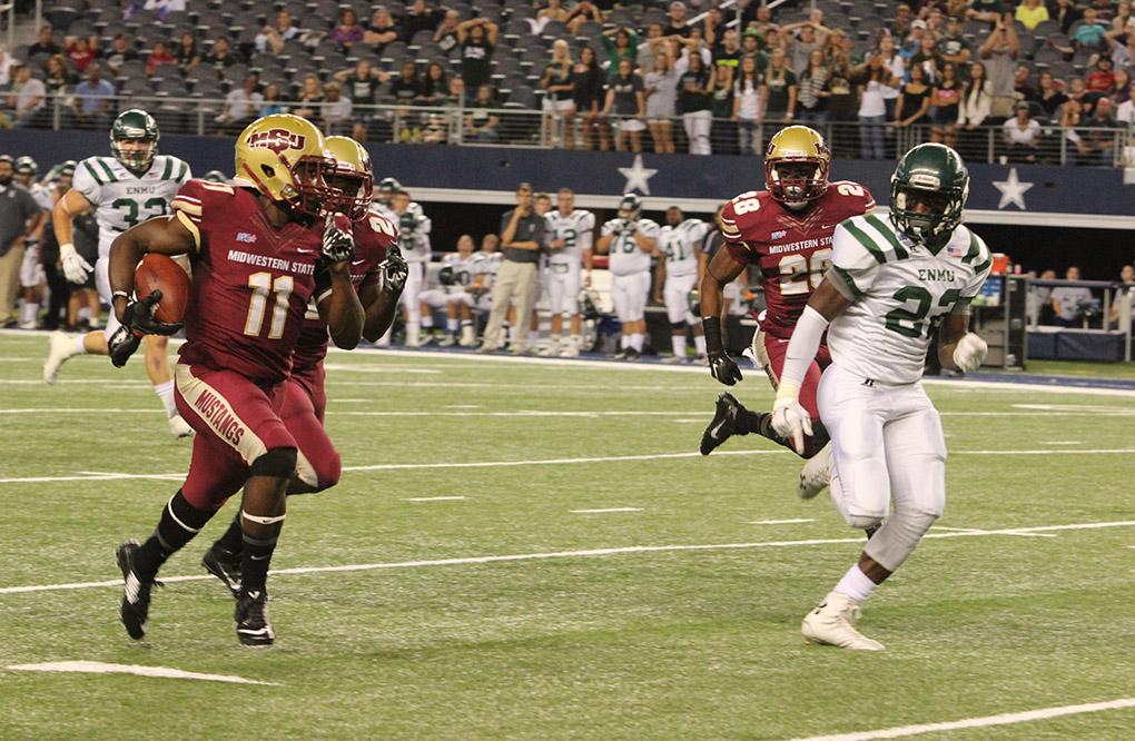 Levy Wilson, junior wide reciever, runs the ball up the field at the Midwestern State University v. Eastern New Mexico game at AT&T Cowboys Stadium in Arlington, Sept. 20, 2014. Photo by Bradley Wilson
