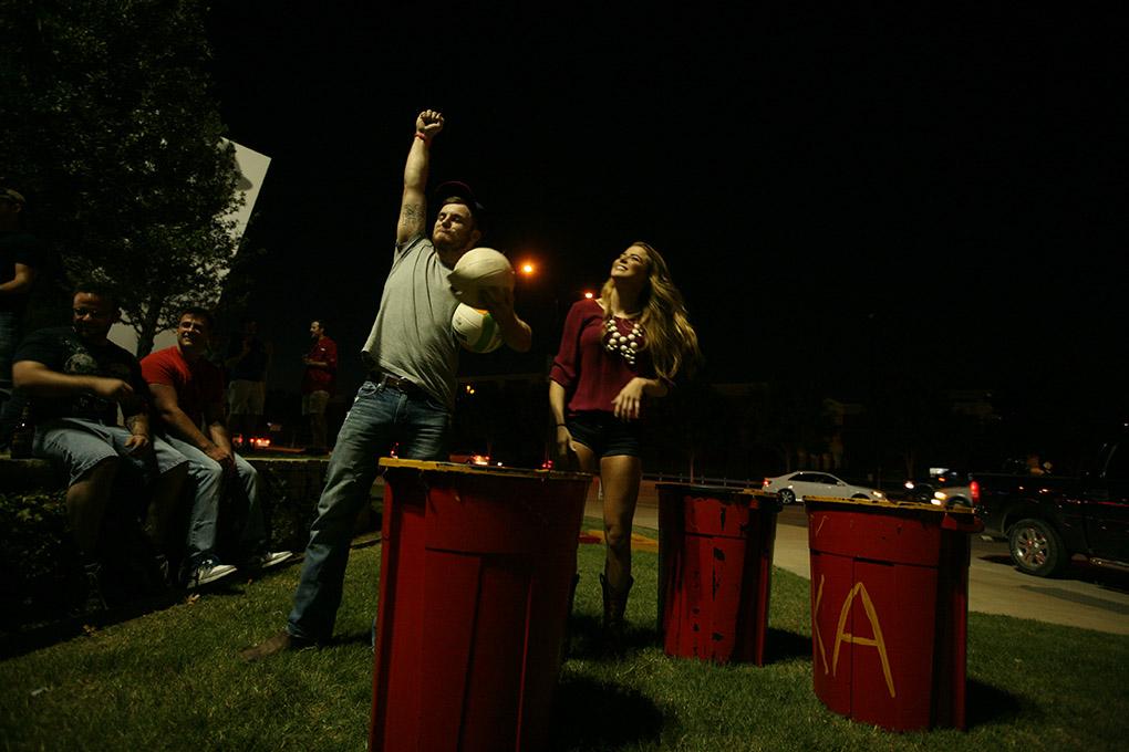 Richard Millsap, geology sophomore, and Destiny Zynda, excercise physiology sophomore, win their first game of trashketball at the tailgate during the Midwestern State University v. Eastern New Mexico game at AT&T Cowboys Stadium in Arlington, Sept. 20, 2014. Photo by Bradley Wilson