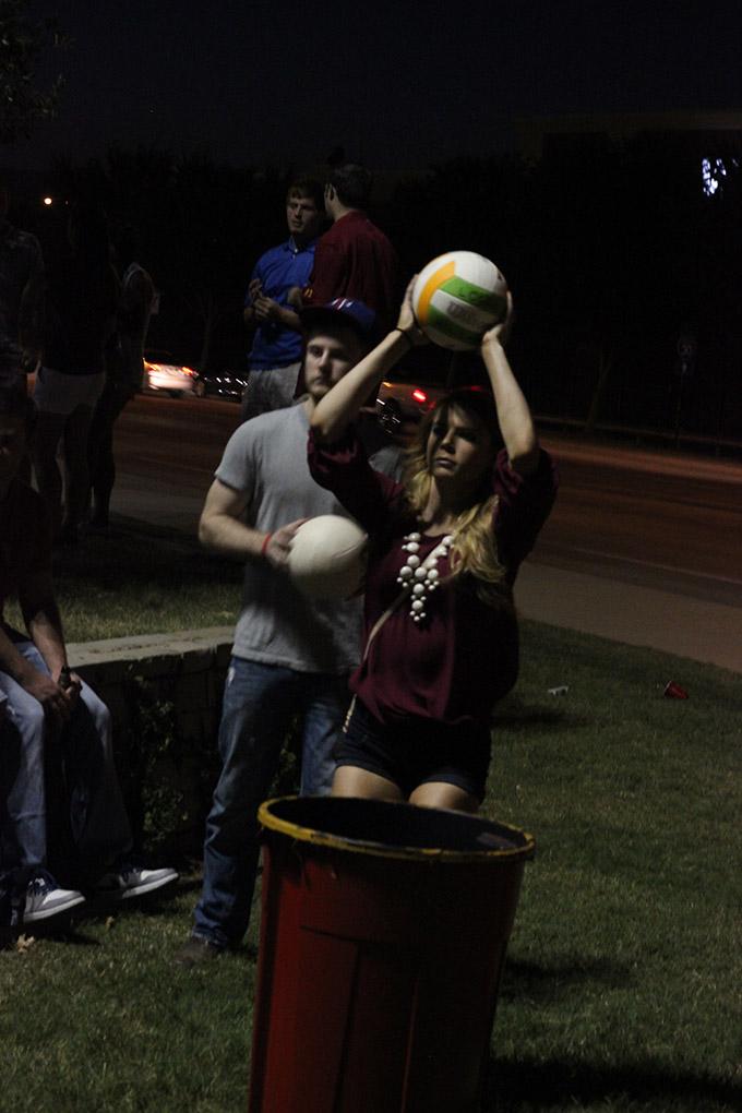 Destiny Zynda, excercise physiology sophomore, teamed up with Richard Millsap, geology sophomore, to play trashketball at the tailgate outside the Midwestern State University v. Eastern New Mexico game at AT&T Cowboys Stadium in Arlington, Sept. 20, 2014. Photo by Rachel Johnson