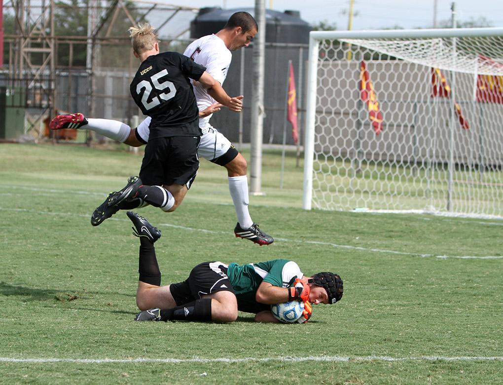 MSU's Kalen Ryden, mass communication senior, and Colorado-Colorado Springs' freshman Jake McAllister jump over MSU's goal keeper Nick Petolick, business management junior, as Petolick holds on to the ball. Photo by Lauren Roberts