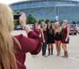 Avery Stout, radiology sophomore, Kylie Goble, nursing junior, Hannah Schulte, radiology sophomore, Ashlee Hasten, radiology senior, Kourtnie Renfro, dental hygene junior, get their picture taken by a friend outside of the AT&T Stadium while tailgating during the game. Photo by Rachel Johnson