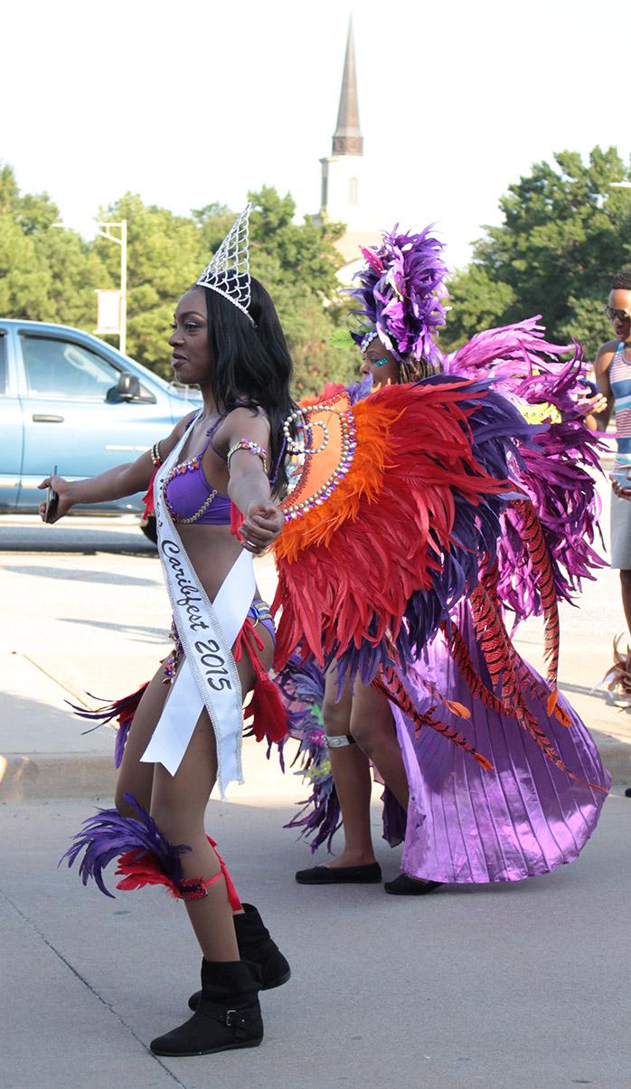 Jorrey Martin, special education sophomore and Miss CaribFest 2015, leads the part of the parade, behind the truck with the D.J. playing music, with dance in the 2015 CaribFest Parade, Sept. 25. Photo by Kayla White