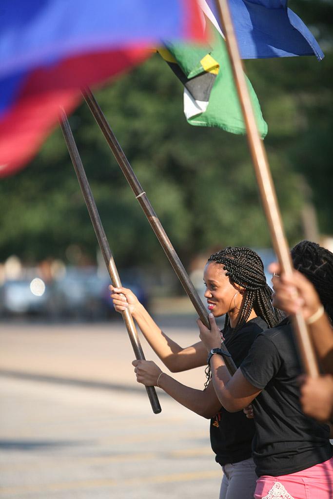 Yvonne Albert, chemistry senior, carries one of the country's flags during  the 2015 CaribFest Parade, Sept. 25, Photo by Bradley Wilson