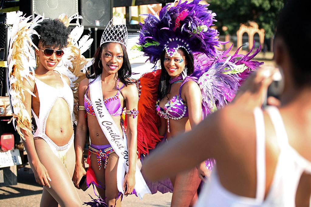 Larissia Gumbs, psychology sophomore, Jorrey Martin, special education sophomore, and Joslyn Le Blanc, biology sophomore, get a picture taken of them during the beginning of the 2015 CaribFest Parade. Sept. 25. Photo by Francisco Martinez