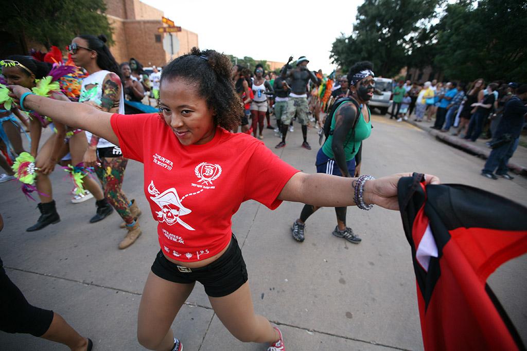 Iman Mendes, management information systems senior, dances along with other participants during the 2015 CaribFest Parade, Sept. 25. Photo by Bradley Wilson