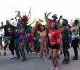 Participants in the 2015 CaribFest Parade celebrate by dancing, shouting, and waving flags down Council Drive following a van with a D.J. and music, Sept. 25. Photo by Kayla White