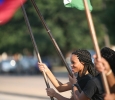 Yvonne Albert, chemistry senior, carries one of the country's flags during the 2015 CaribFest Parade, Sept. 25, Photo by Bradley Wilson