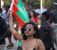 Orianna Law, nursing sophomore, holds a flag while she dances along the truck blasting festive Caribbean music in the CaribFest Parade, Sept. 25. Photo by Francisco Martinez