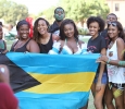 A group gathers before the Caribfest Parade to take a group photo with a flag of the Bahamas in the green space outside Clark Student Center where students got their bodies painted Sept. 25. Photo by Francisco Martinez