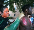 Aireanna Chavez, atheltic training freshman, paints the face of Austun Lambert, undecided freshman, in the Green Space where student painted each other for the 2015 CaribFest Parade, Sept. 25. Photo by Bradley Wilson