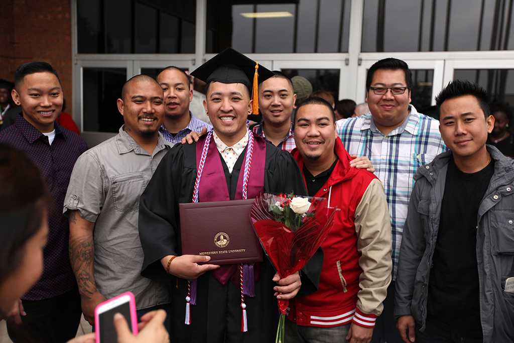 Timothy Muongchanh, nursing, poses with his family and friends after the Commencement Ceremony in Kay Yeager Coliseum Dec. 12, 2015. Photo by Francisco Martinez