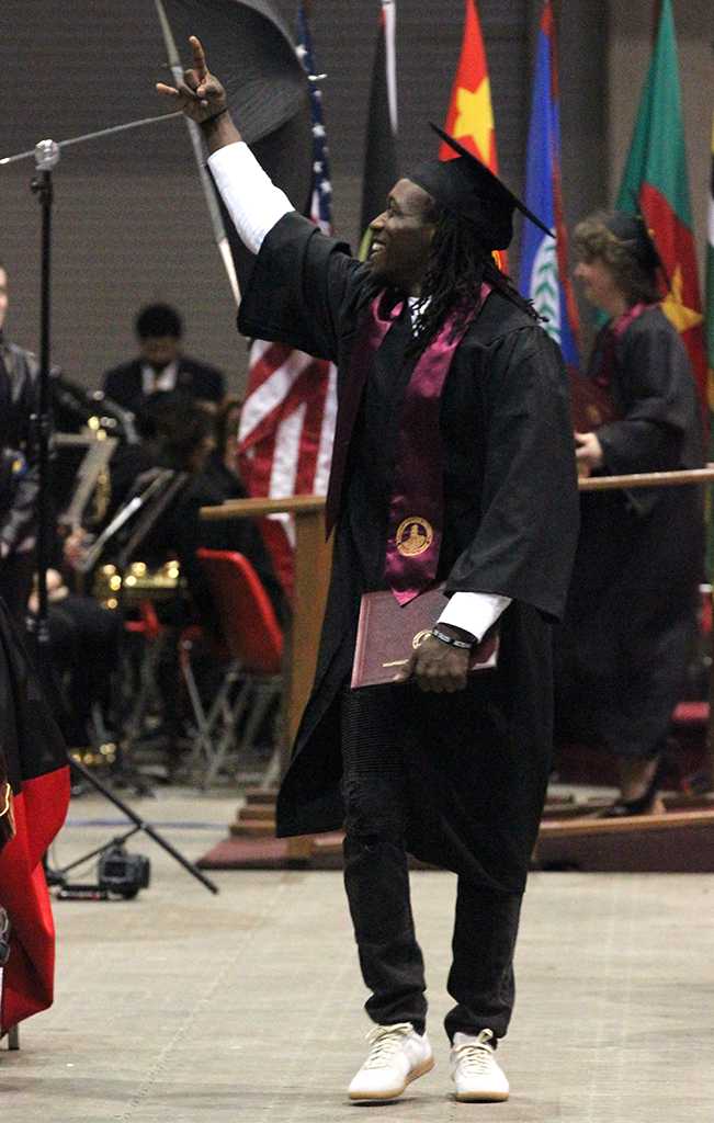 Bernard Griffin Jr., criminal justice, acknowledges members in the audience, then started to dance and shake hands with other graduates in attendance in the Kay Yeager Coliseum, Dec. 12. Photo by Rachel Johnson