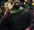 Rodney Holmes, excersize physiology, waves to his family members in the audience during the part in the ceremony where they have the graduates recognize their friends, family, professors, and people who helped them get to graduation day in Kay Yeager, Dec. 12. "I'm just feeling excitement, it's just crazy because O wamt tp say i'm the first on my dad's side of the family to finish this higher education," Holmes said. Photo by Rachel Johsnon
