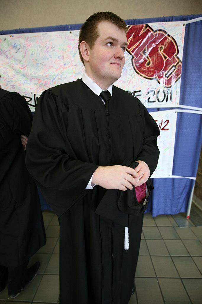 Robert Baker, history, waits to be let into a room where they organize the graduates by major in the Multi-Purpose Event Center at the Midwestern State University graduation, May 16, 2015 at the Kay Yeager Coliseum. Photo by Rachel Johnson