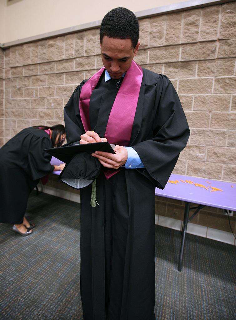 Christian tanner, excersize physiology, fills out his card with his name and information before the Midwestern State University graduation, May 16, 2015 at the Kay Yeager Coliseum. Photo by Rachel Johnson