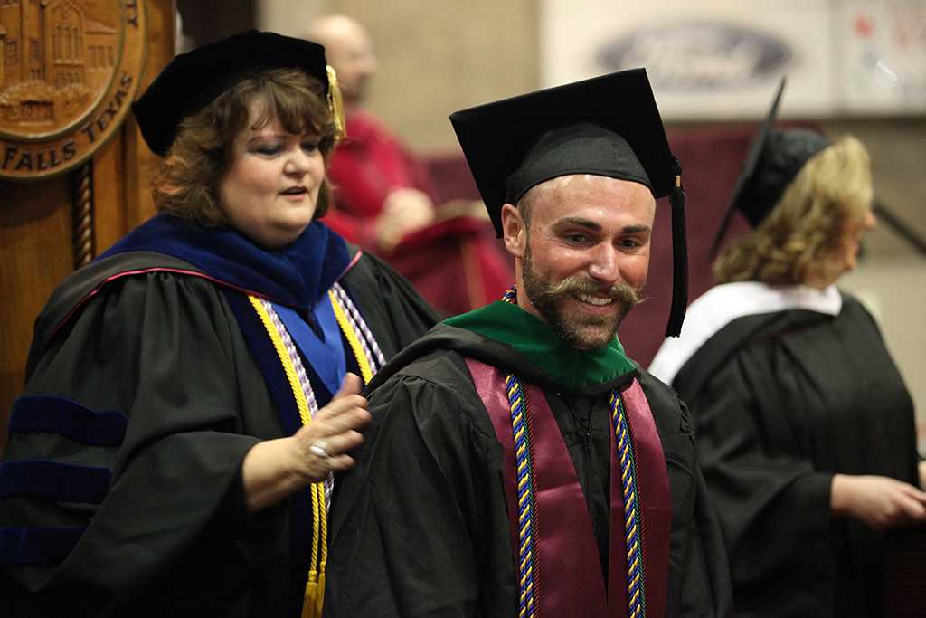 Robin Goodfellowe, science and mathematics senior, receives his masters hood at Midwestern State University graduation, May 16, 2015 at the Kay Yeager Coliseum. Photo by Francisco Martinez