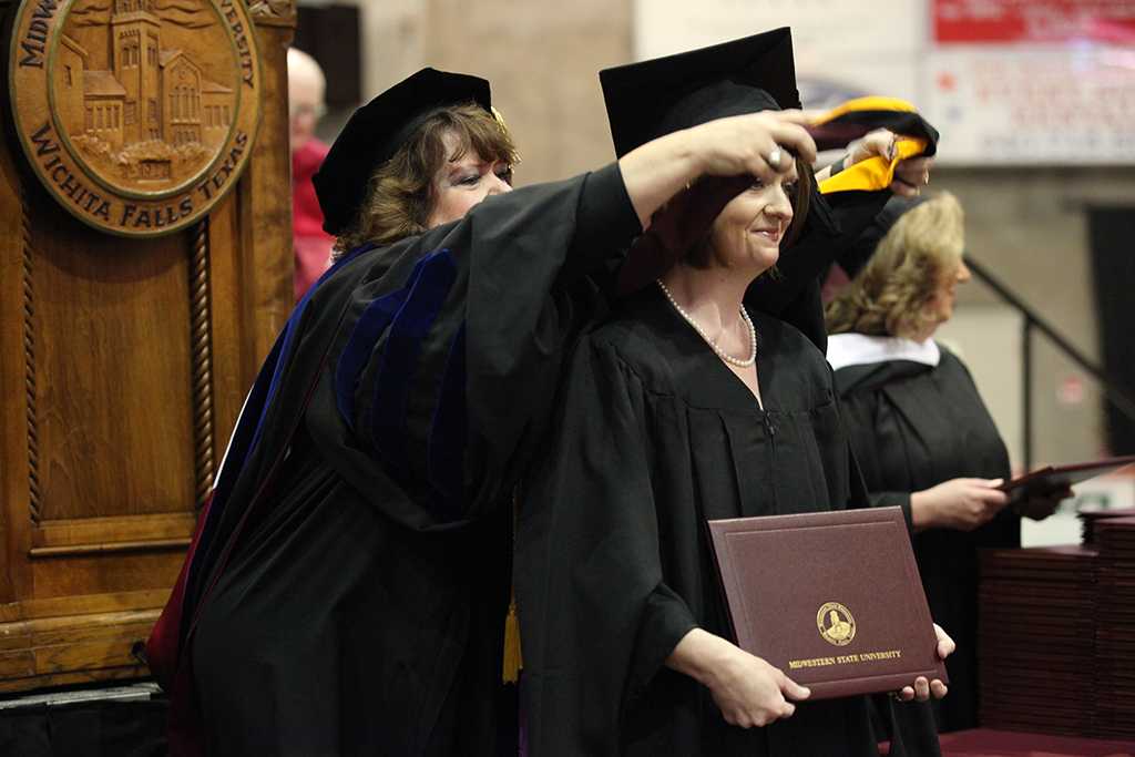 Melanie Sharp, nursing senior, receives her masters degree hood at Midwestern State University graduation, May 16, 2015 at the Kay Yeager Coliseum. Photo taken by Francisco Martinez