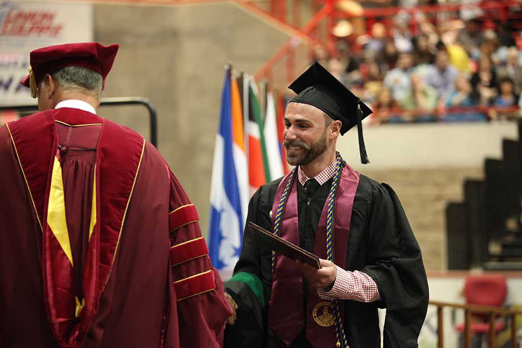 Robin Goodfellowe, science and mathematics senior, receives his deploma at Midwestern State University graduation, May 16, 2015 at the Kay Yeager Coliseum. Photo taken by Francisco Martinez