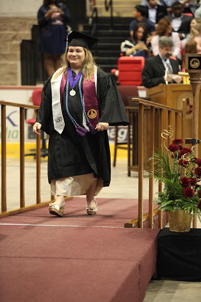 Traci Morrison, interdisciplinary studies senior, walks onto the stage at Midwestern State University graduation, May 16, 2015 at the Kay Yeager Coliseum. Photo by Francisco Martinez