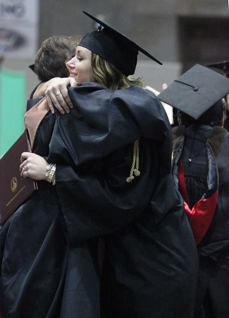 Rian Dilllard, theatre, hugs Laura Jefferson, theater professor, who is now retiring, at the Midwestern State University graduation, May 16, 2015 at the Kay Yeager Coliseum. Photo by Rachel Johnson